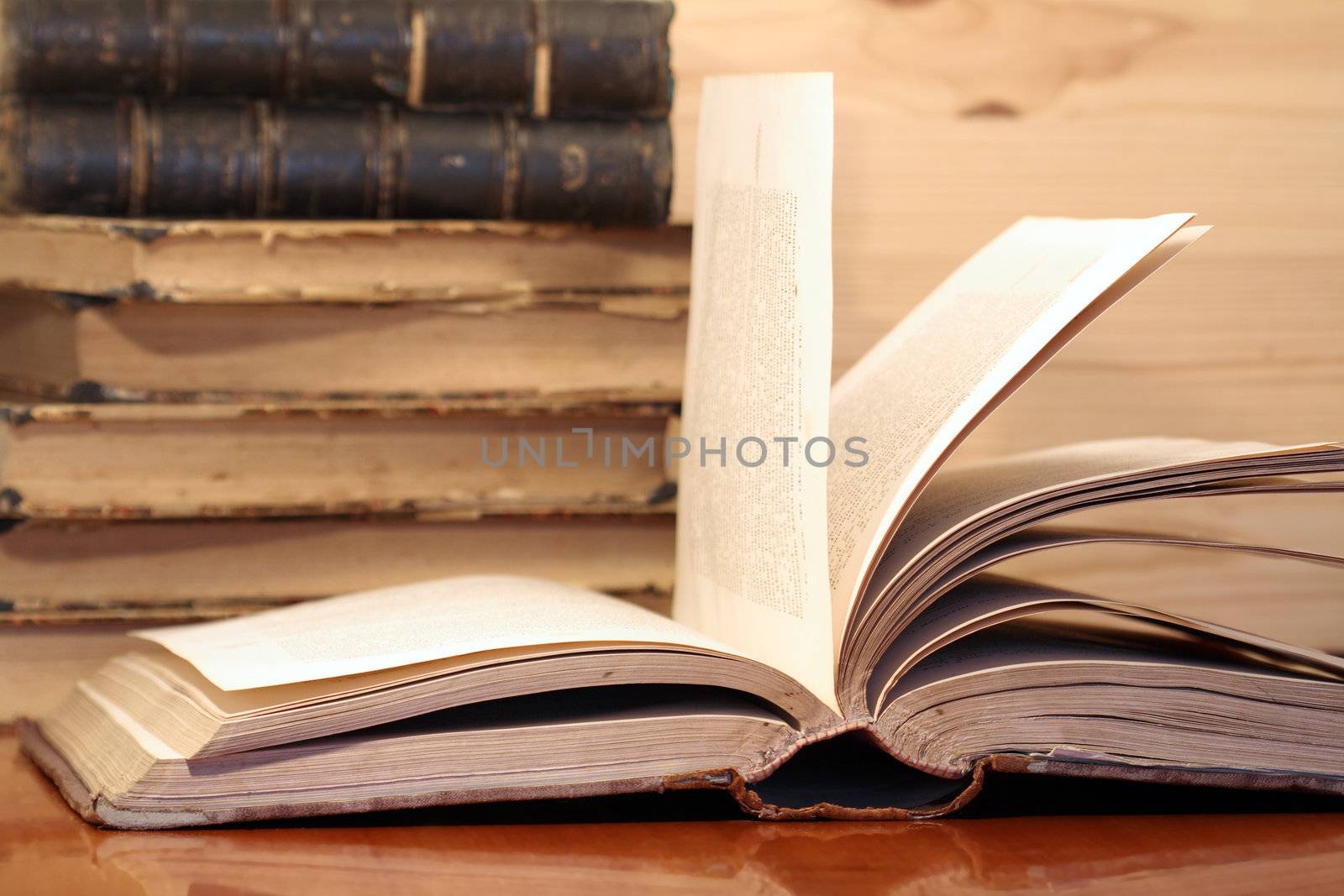Stack of old books on wooden background