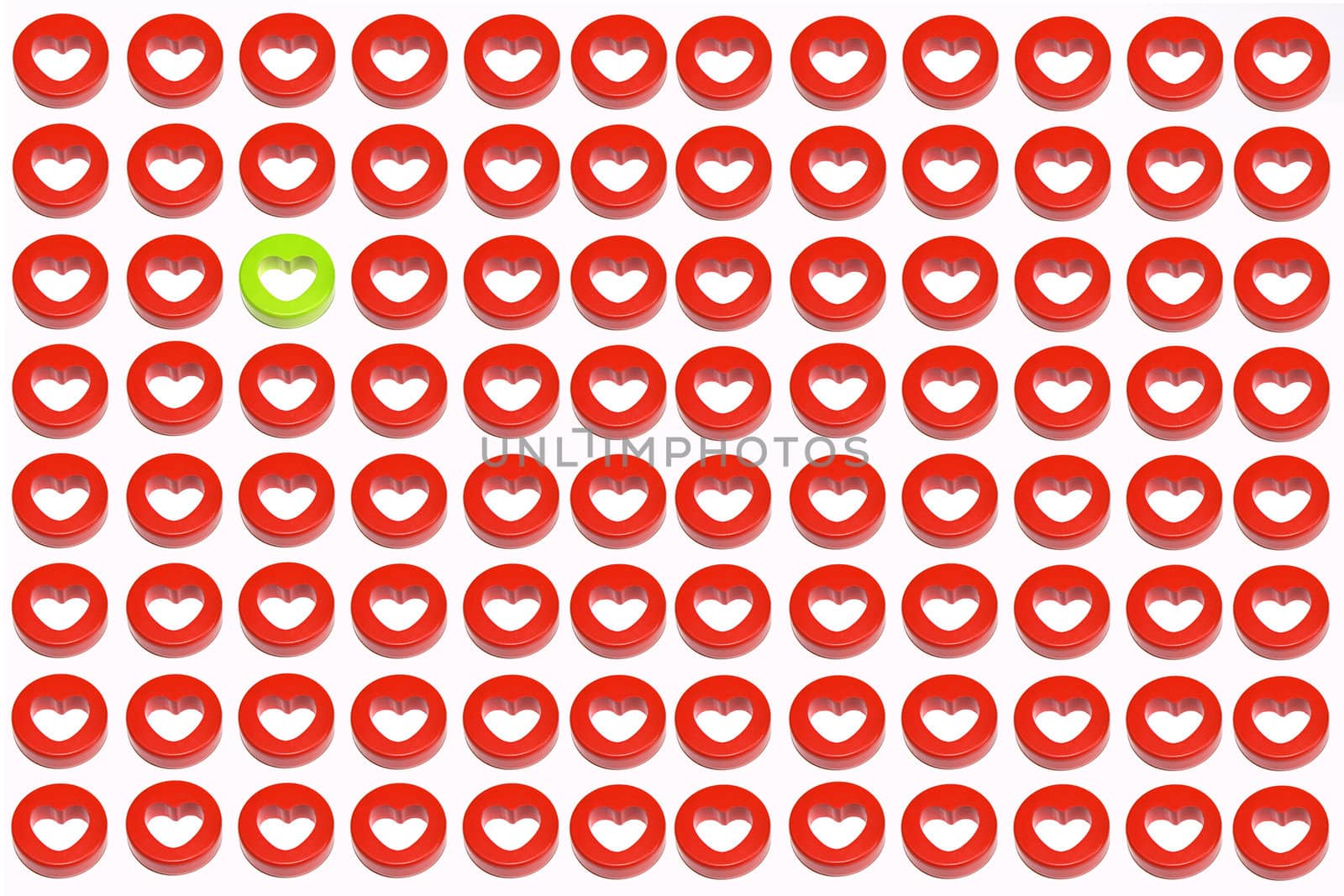 A single green heart surrounded by a crowd of red hearts