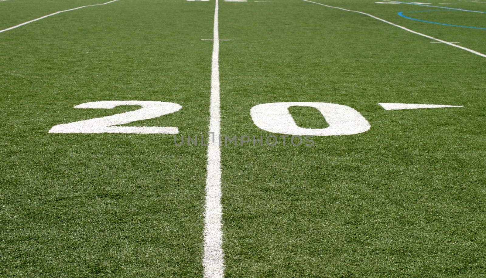 Green football field with large yard numbers.