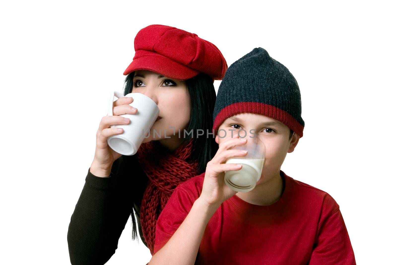An adult sipping coffee and child drinking a glass of milk
