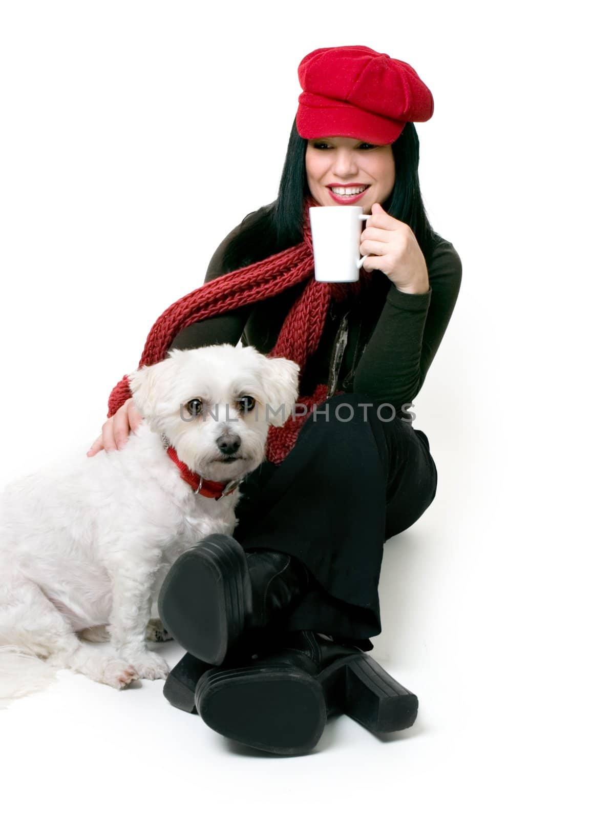 A female adult relaxes with a maltese terrier pet.