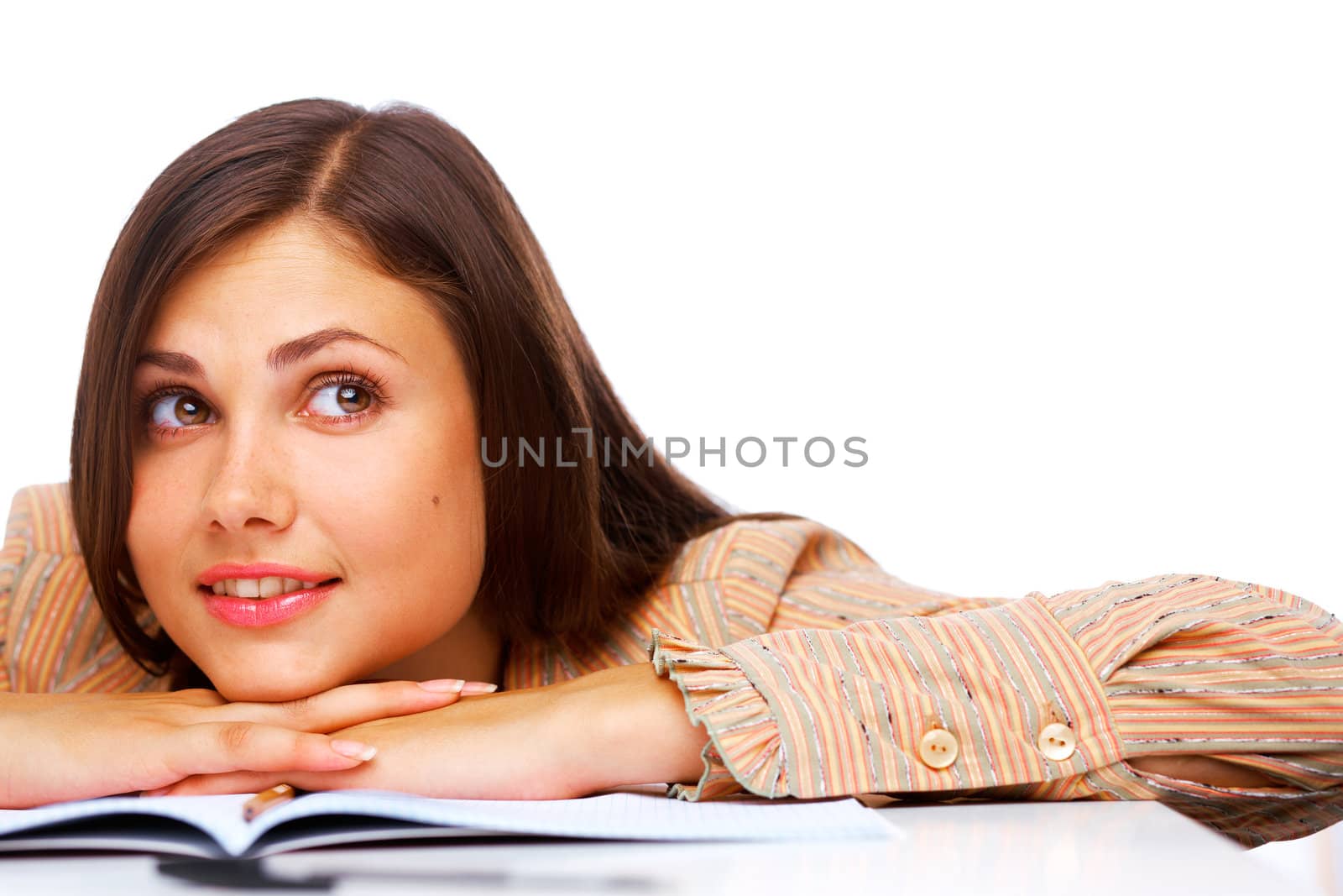 Beautiful female student smiling and looking away over white background