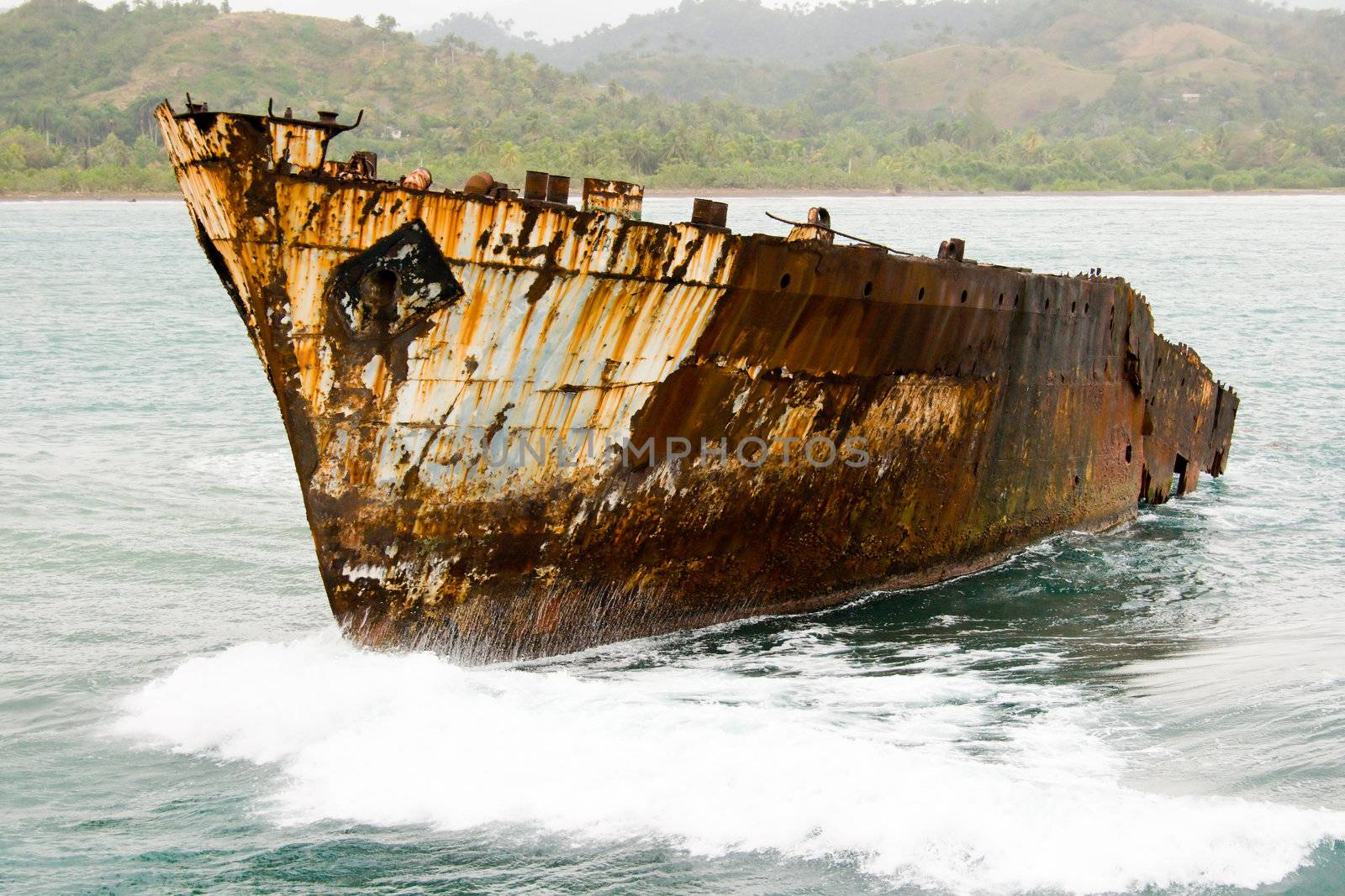 Old rusty ship in a sea after shipwreck near coast. January 2008, Baracoa, Cuba.