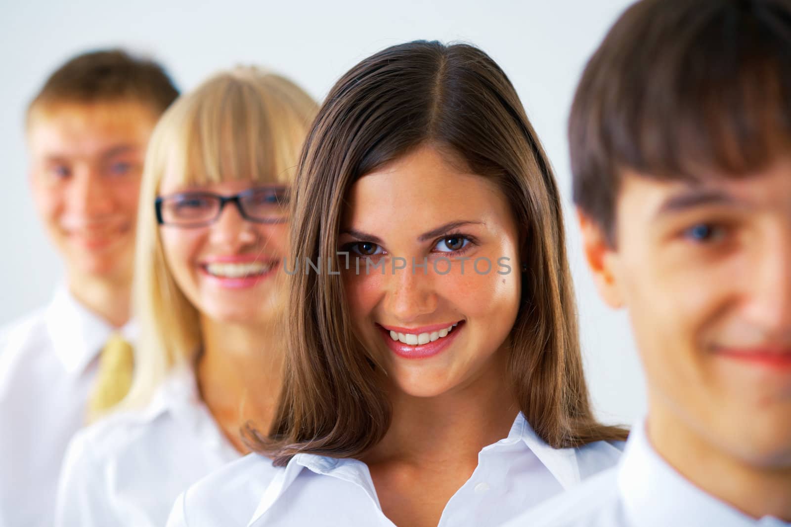  Happy business woman with her colleagues standing in a row.
