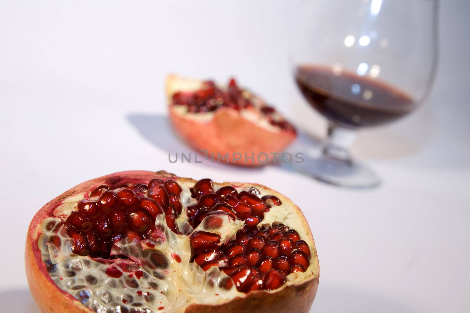 Pomegranate with wine in a white environment