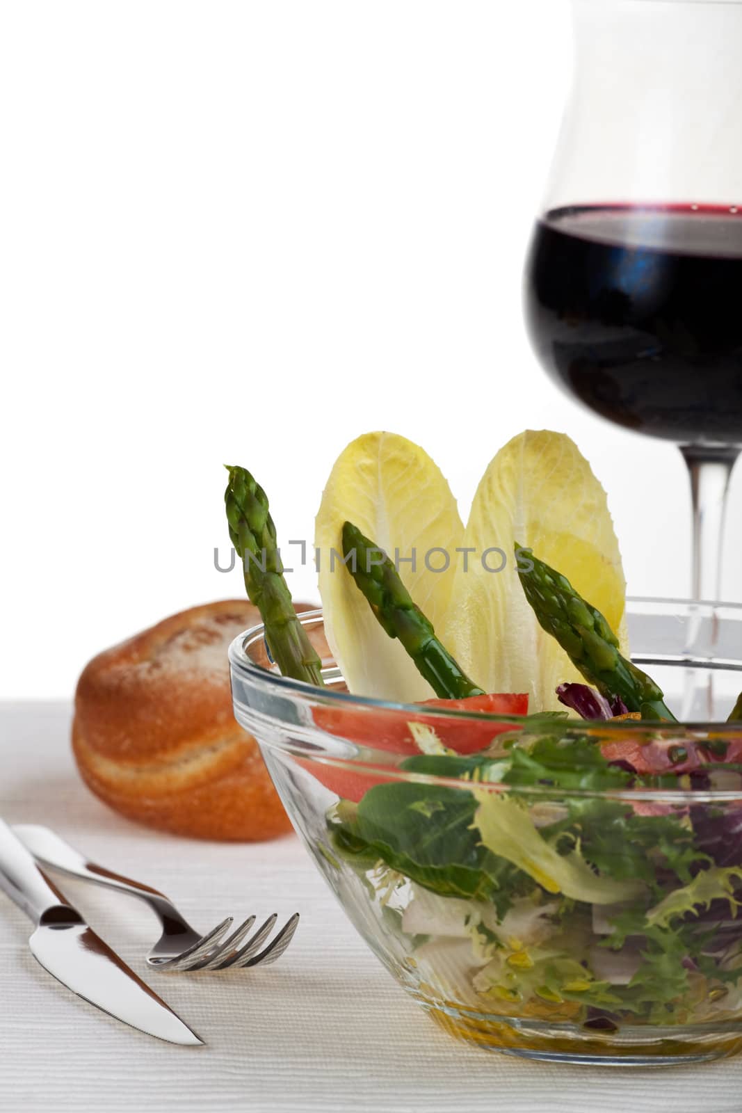 glass bowl of fresh salad with green asparagus