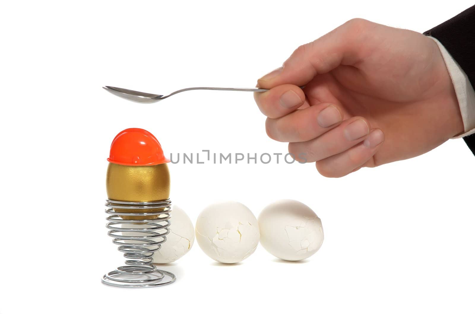 hand broken golden egg on iron stand near by split white egg isolated on white background