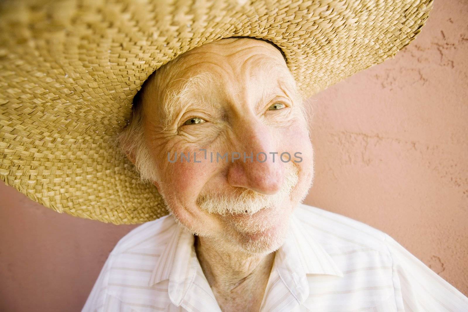 Senior Citizen Man with a Funny Expression Wearing a Straw Cowboy Hat