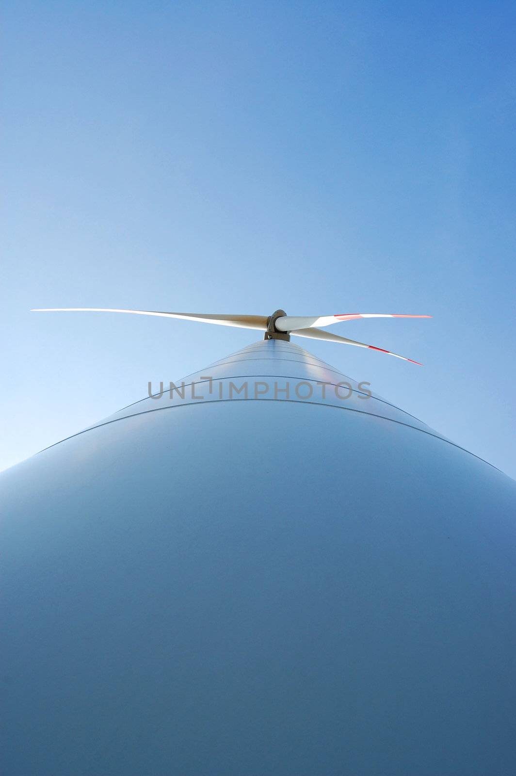 wind turbine under blue sky for alternative energy