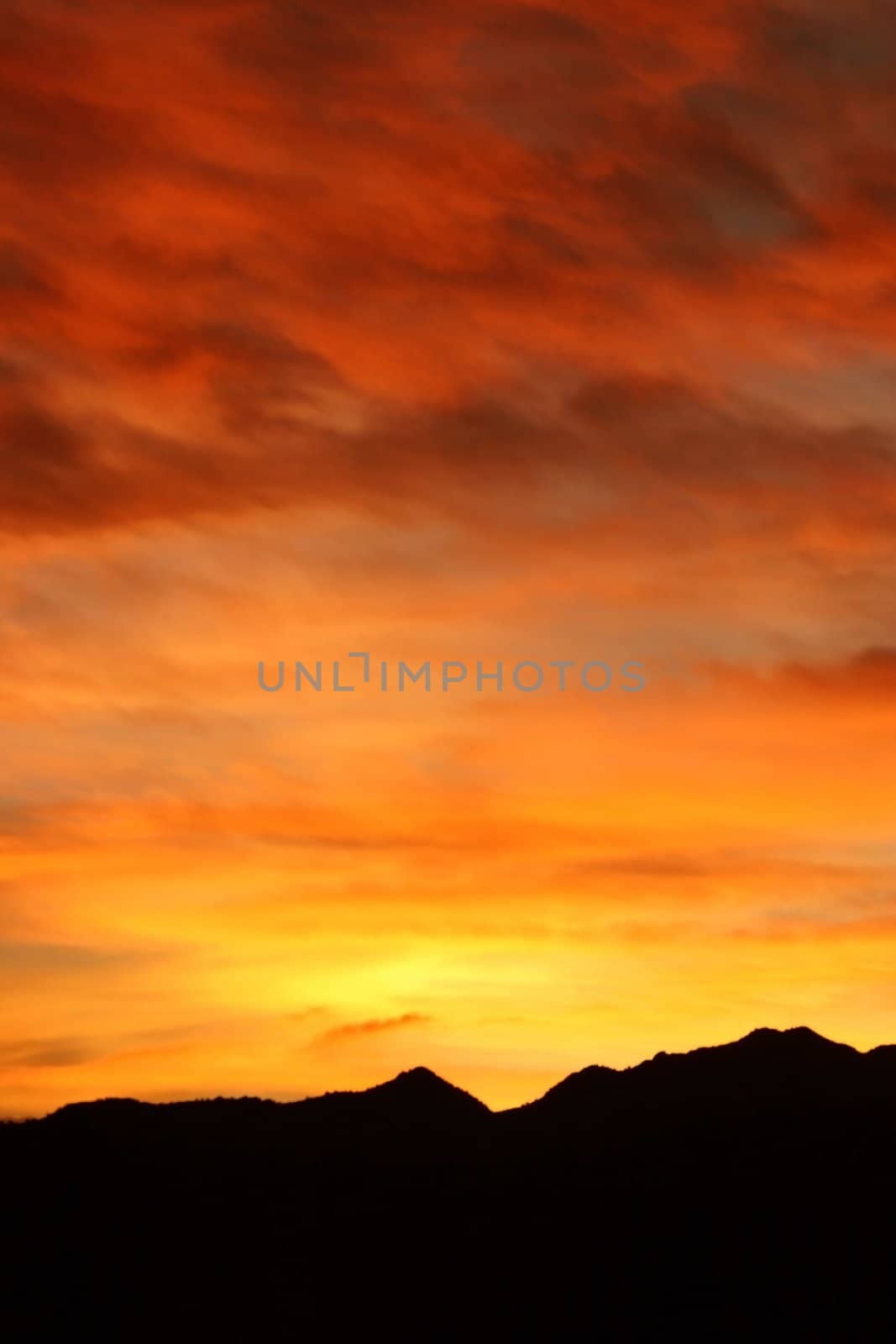 Fiery winter sunrise in the Colorado Rocky Mountains boasts brilliant shades of red, orange, and yellow.