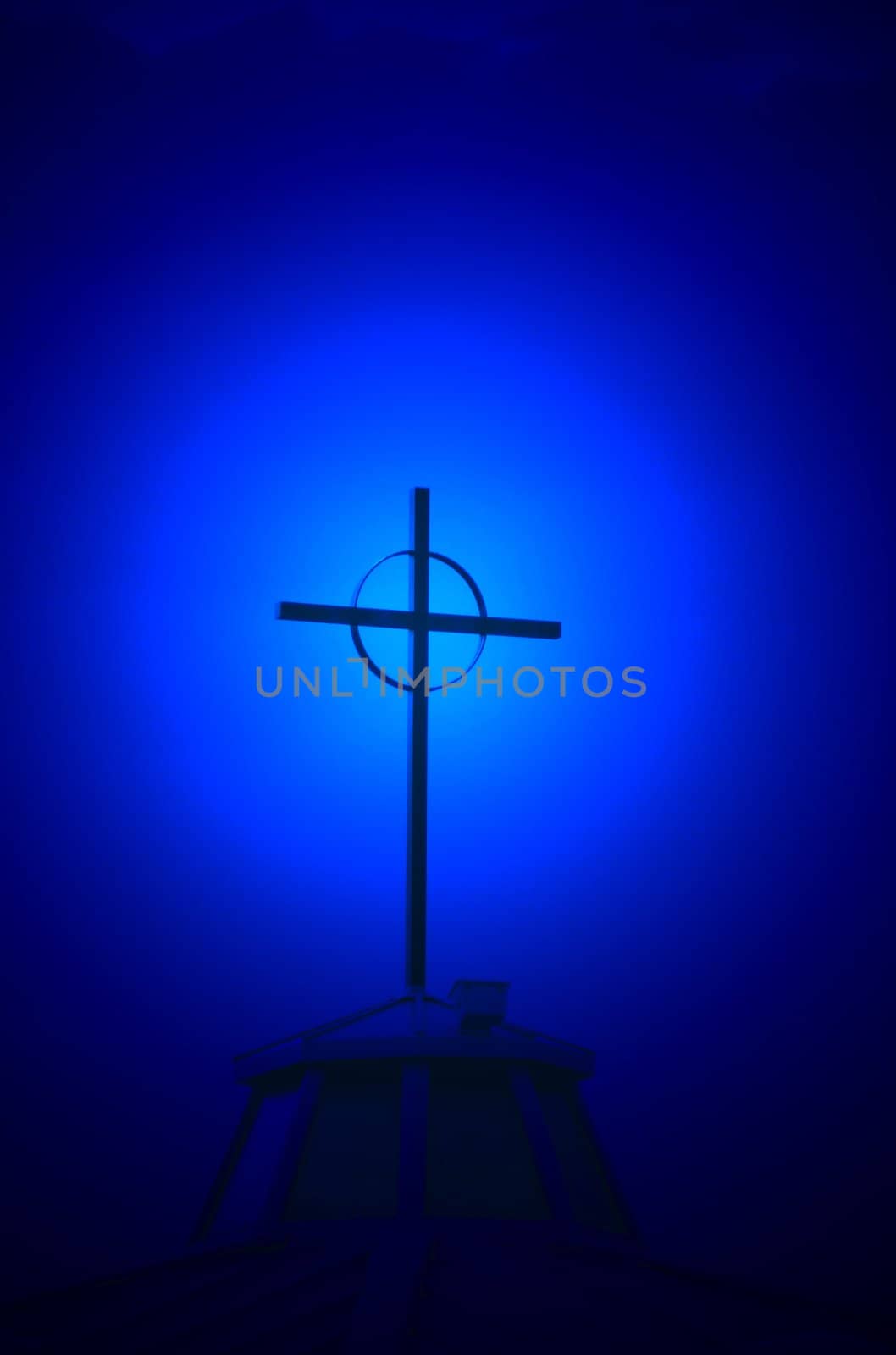 Blue halo effect behind church steeple and cross