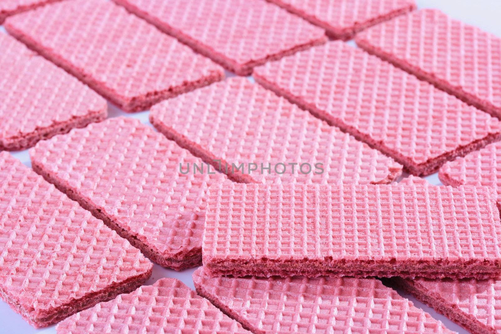 Pink sweet wafers are laid out by equal numbers.