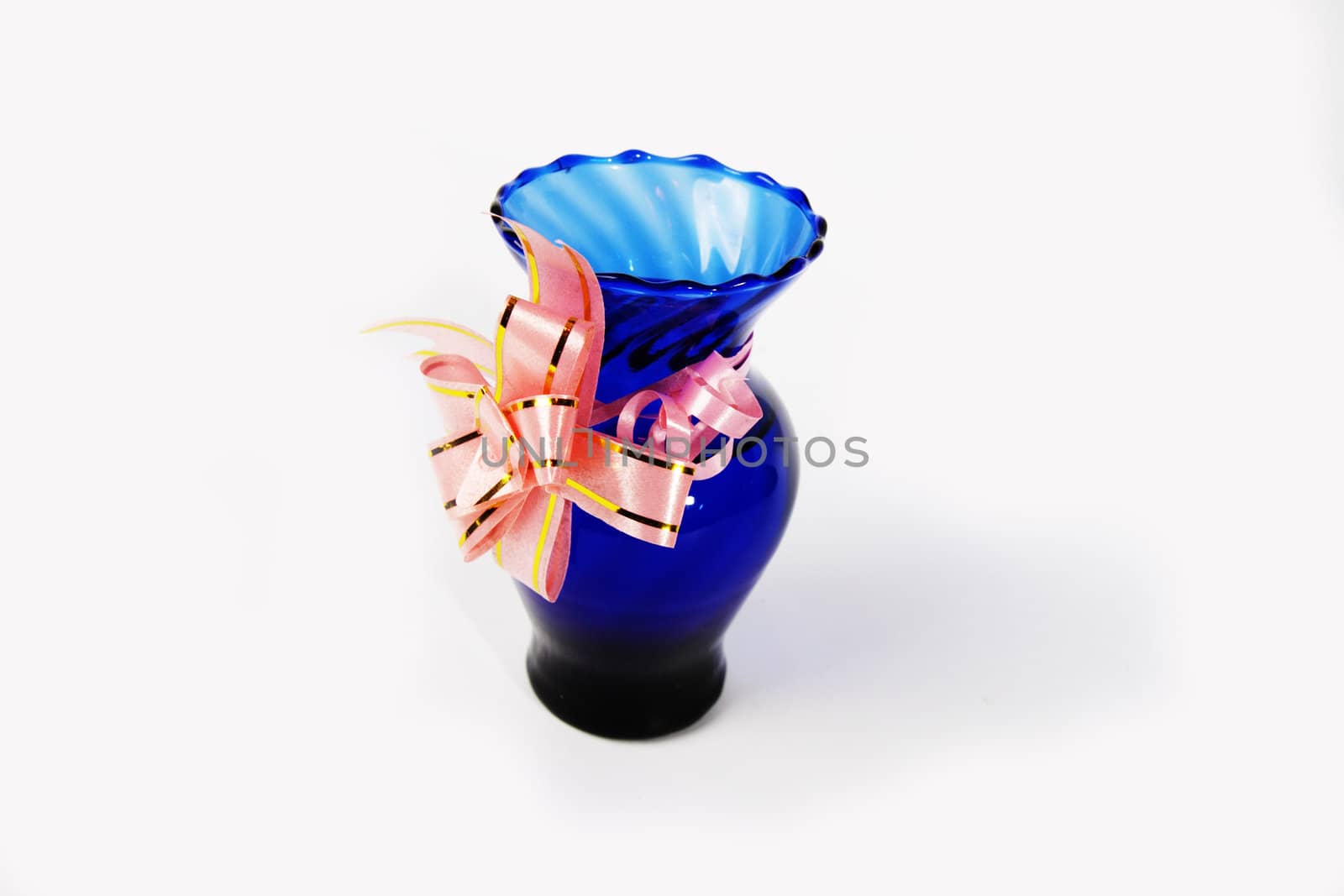 Blue vase with ribbon on white