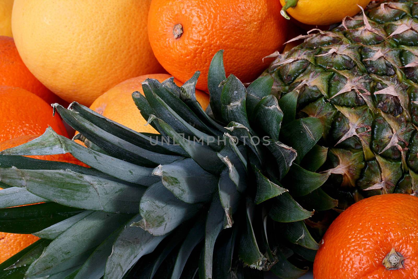 Pineapple close up in an environment of tropical fruit.