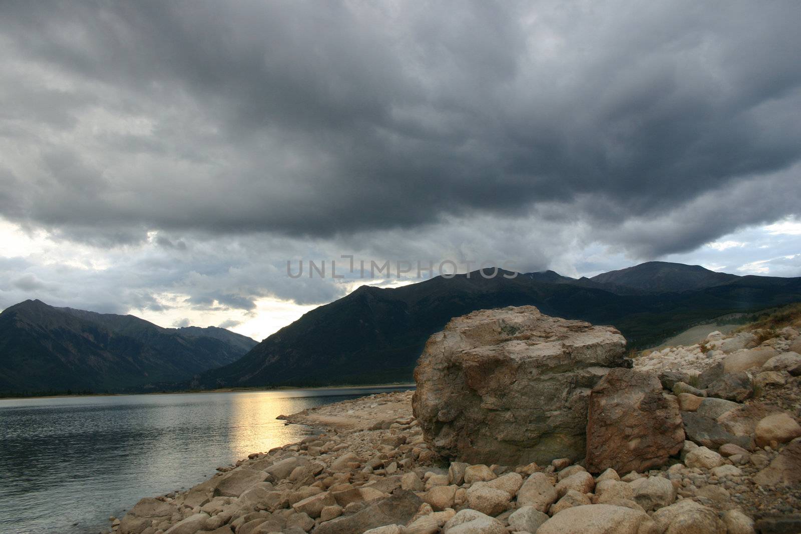 Ominous storm clouds gather over Twin Lakes fishing beach in the Southern Colorado Rocky Mountains