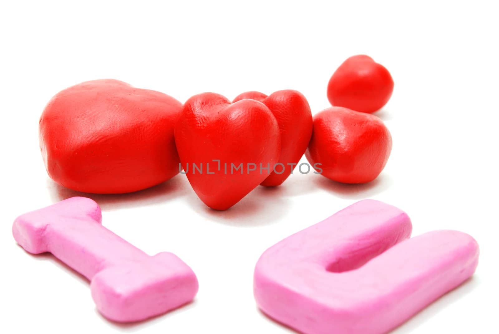 Random Valentine's I Love You Text with Heap of Hearts Made of Red and Pink Plasticine Isolated on White Background