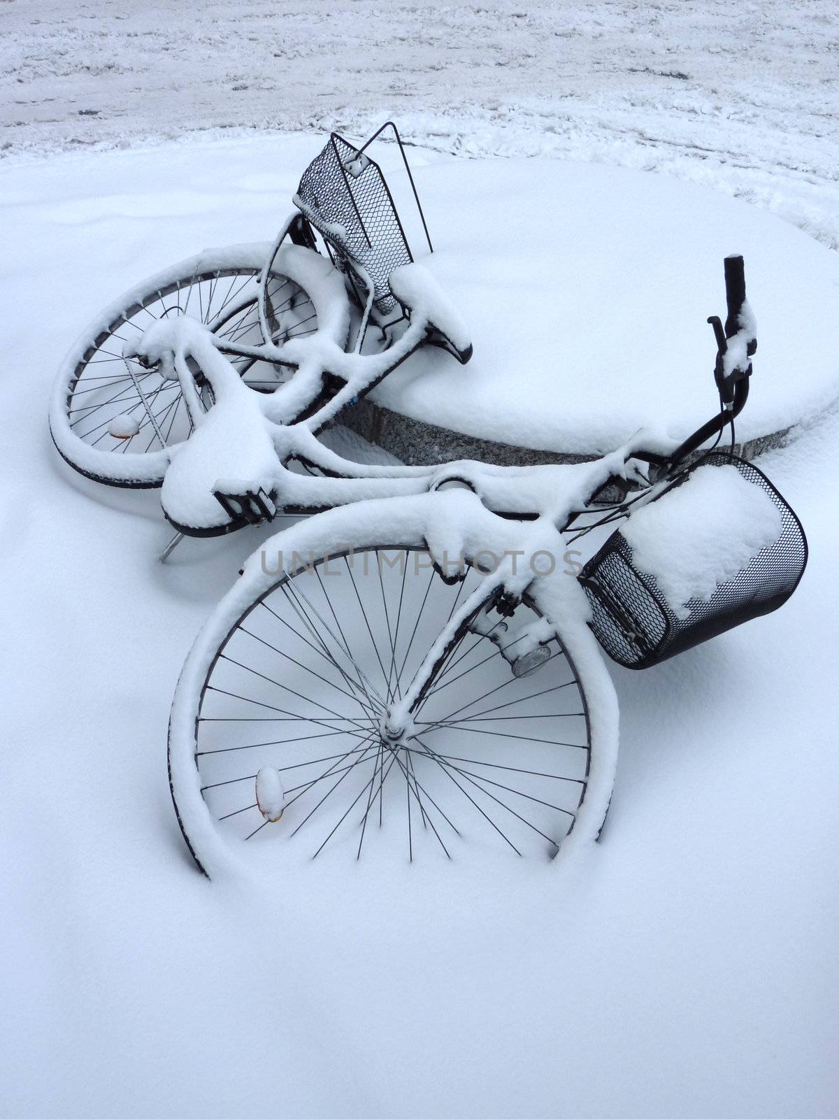 Fallen bicycle covered by snow by Elenaphotos21