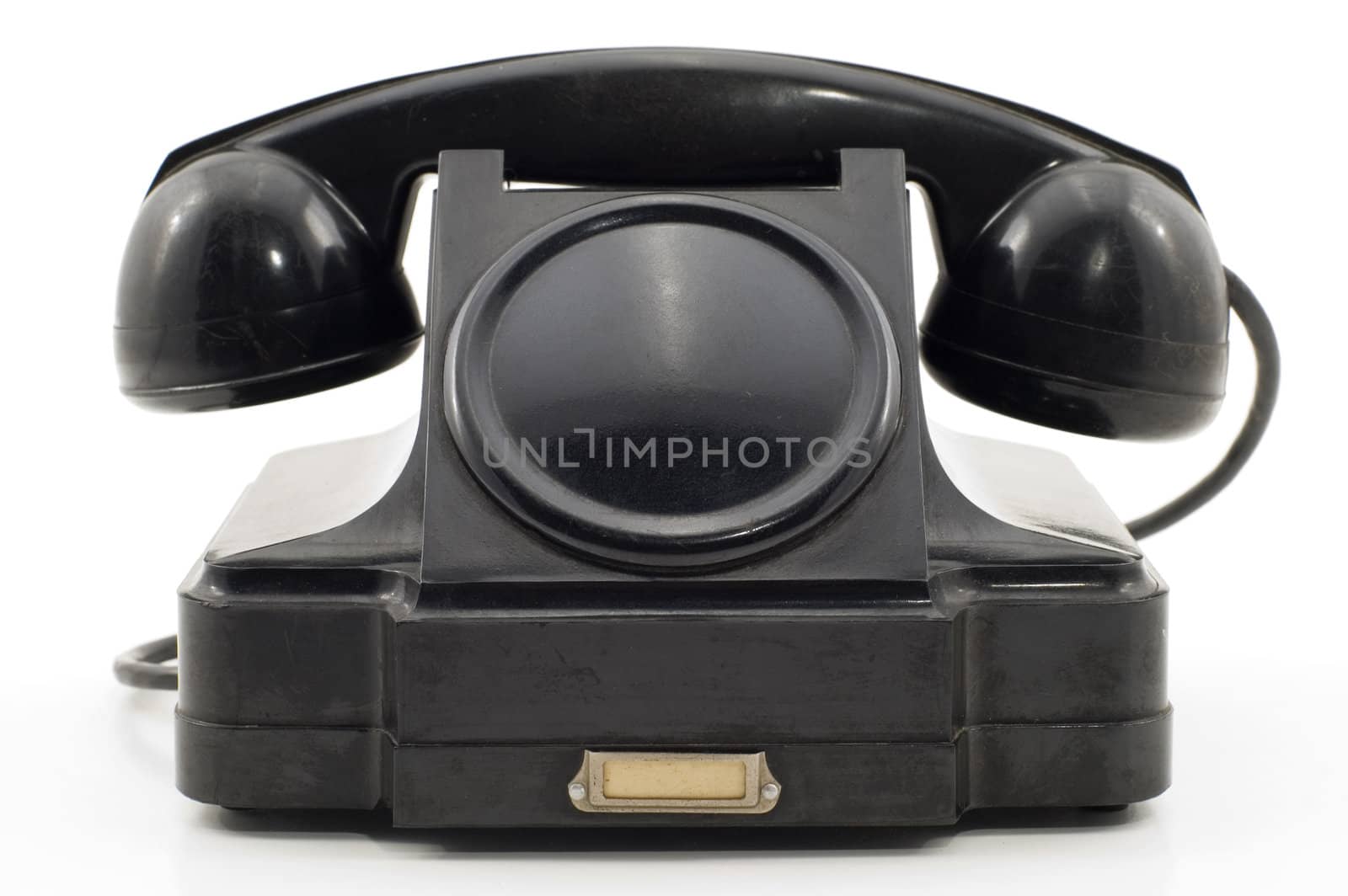 The old telephone of black colour on a white background.