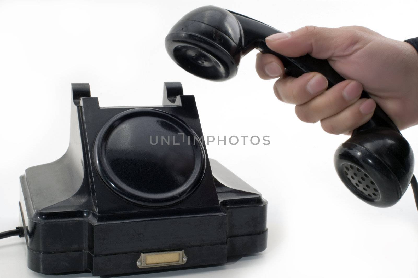 Telephone receiver in hand, isolated on white background.