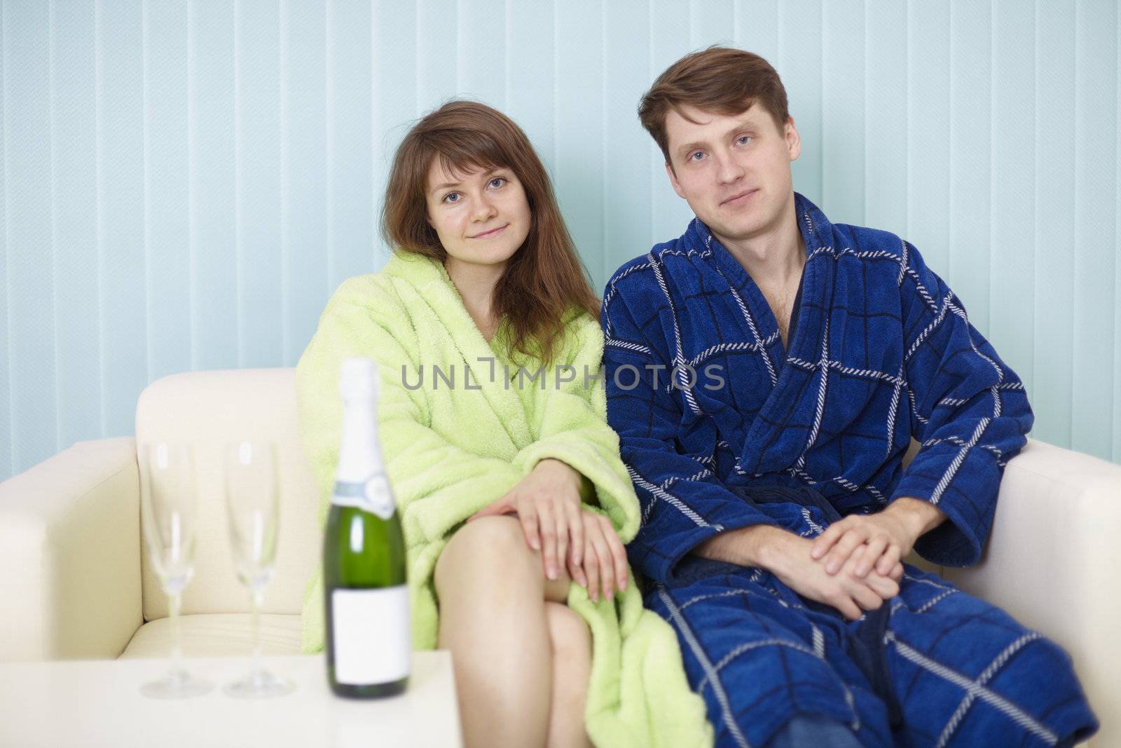 Young happy couple in dressing gowns by pzaxe