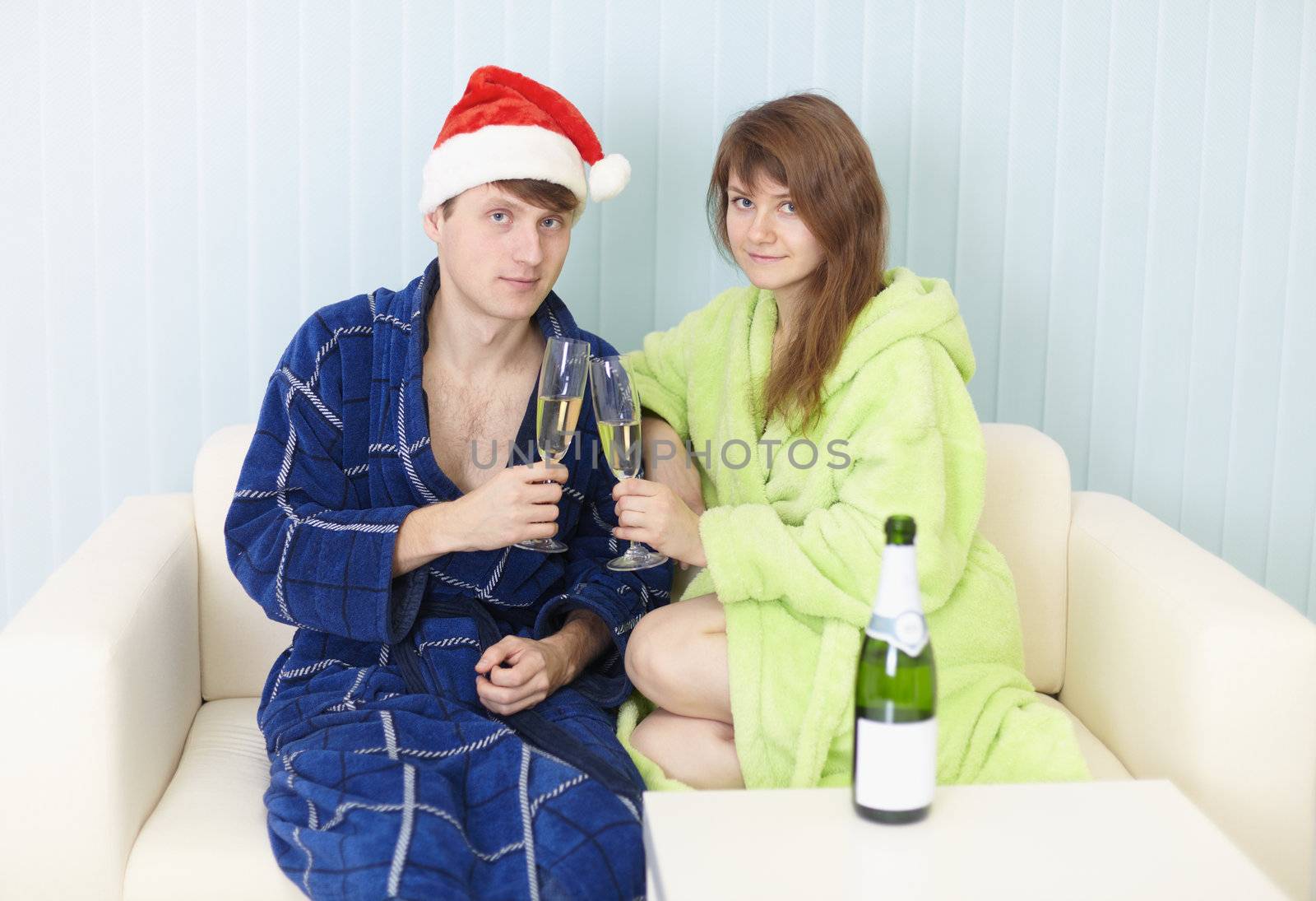 Happy couple in dressing gowns drinks sparkling wine by pzaxe