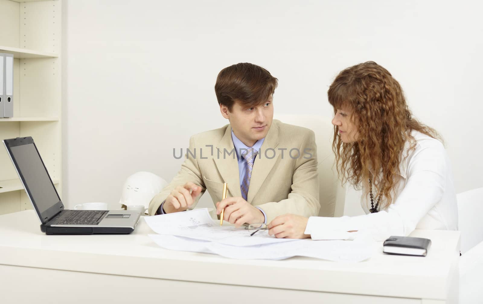 Pair of young businessmen on a workplace in office