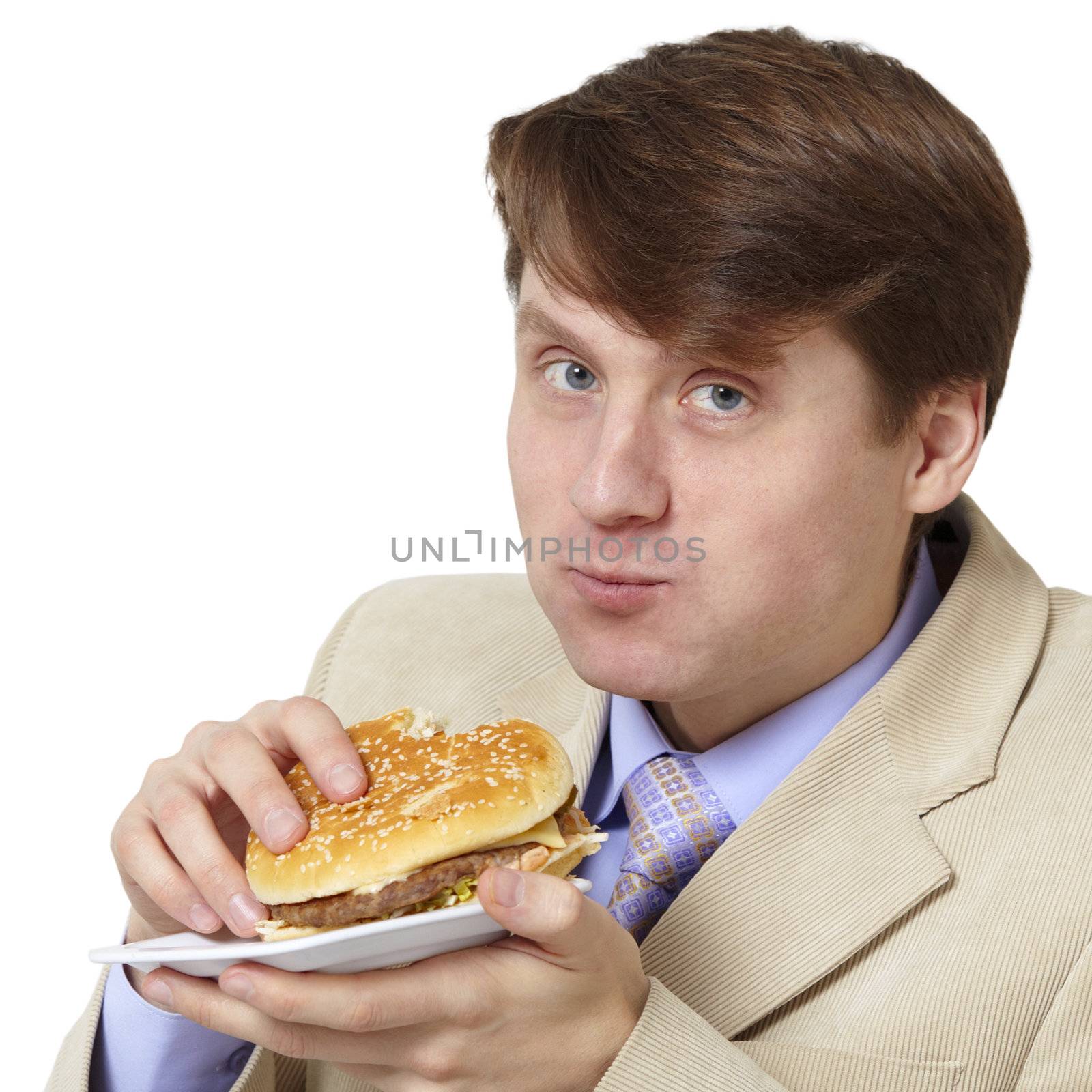 The young businessman is the dinner isolated on a white background