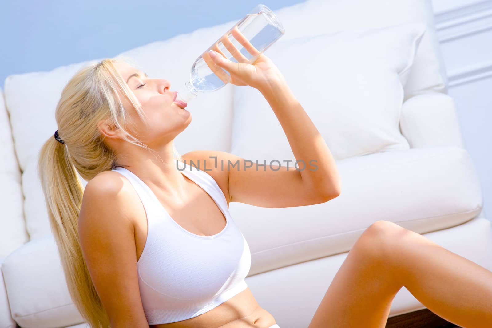 Young Woman Drinking Bottled Water by cardmaverick