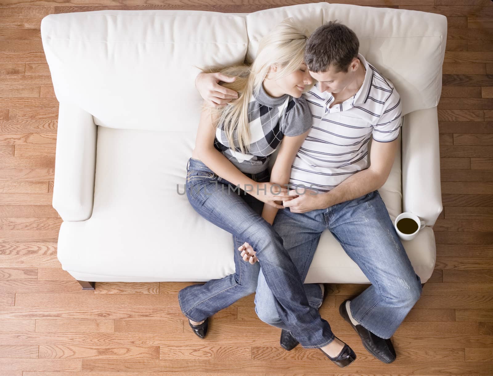 Young Couple Sitting on Love Seat by cardmaverick