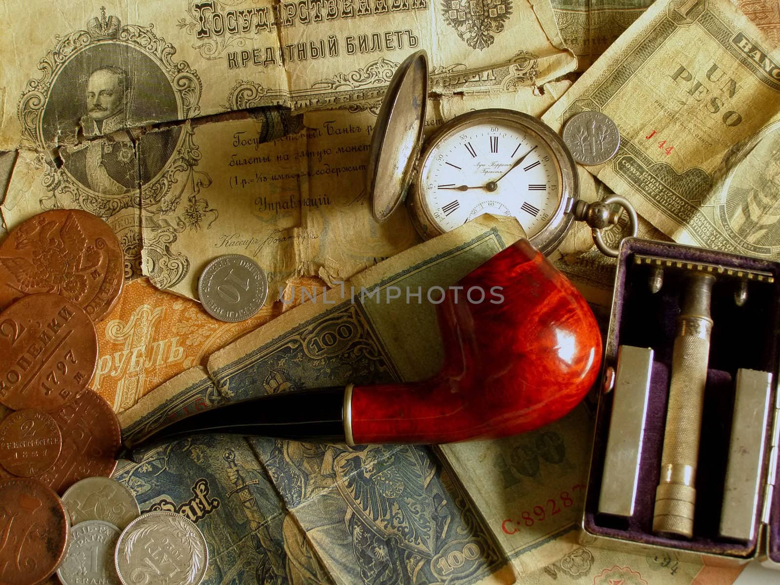 Pipe, old money, old clock and old razor    