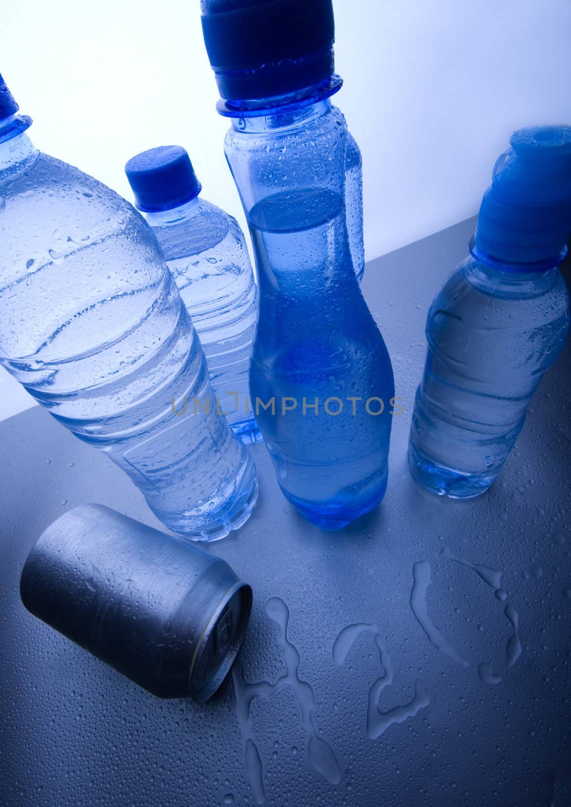 Bottles of mineral water on blue background