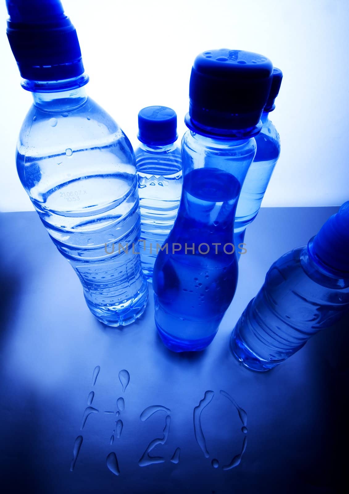 Bottles of mineral water on blue background