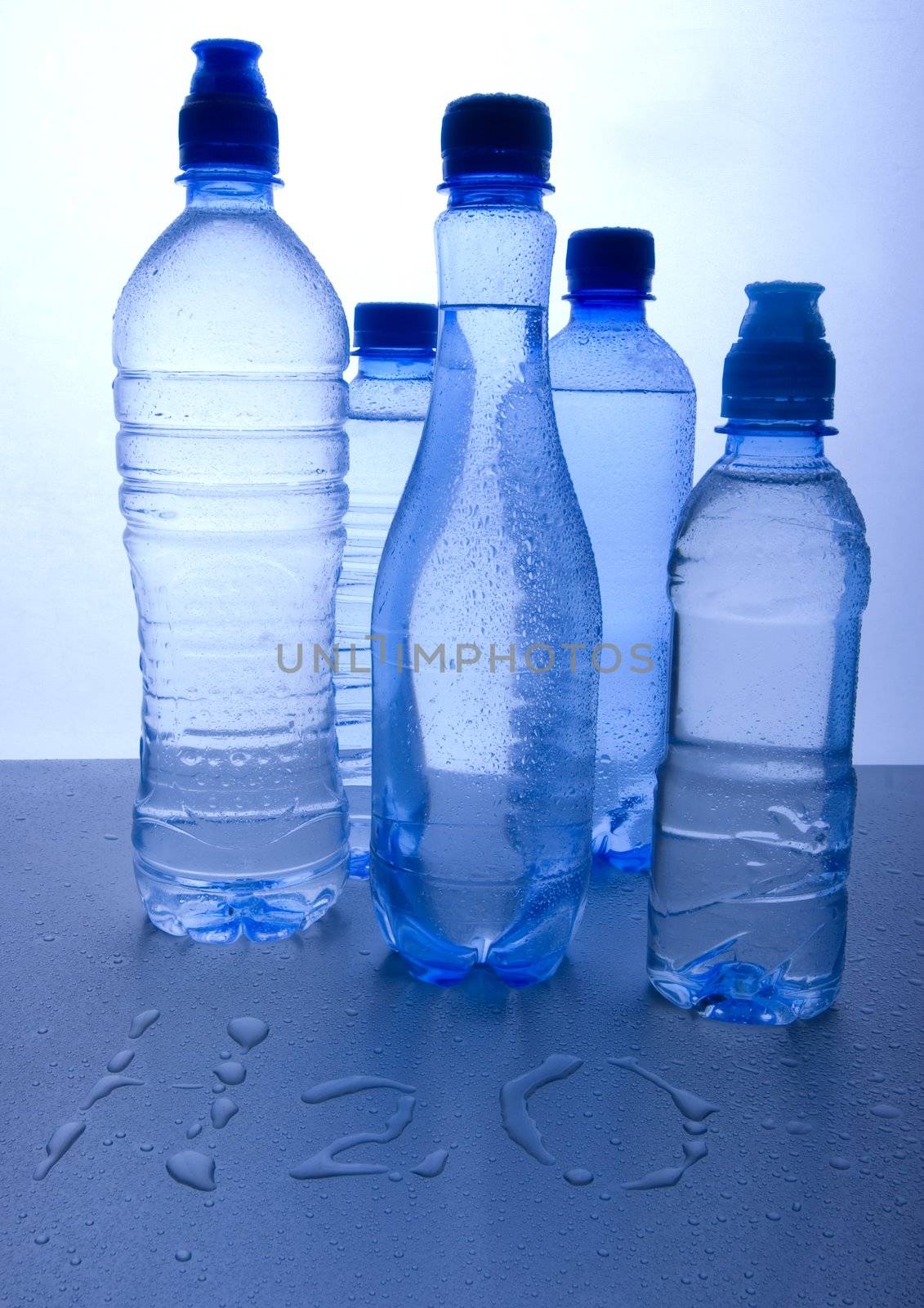 Bottles of mineral water on blue background