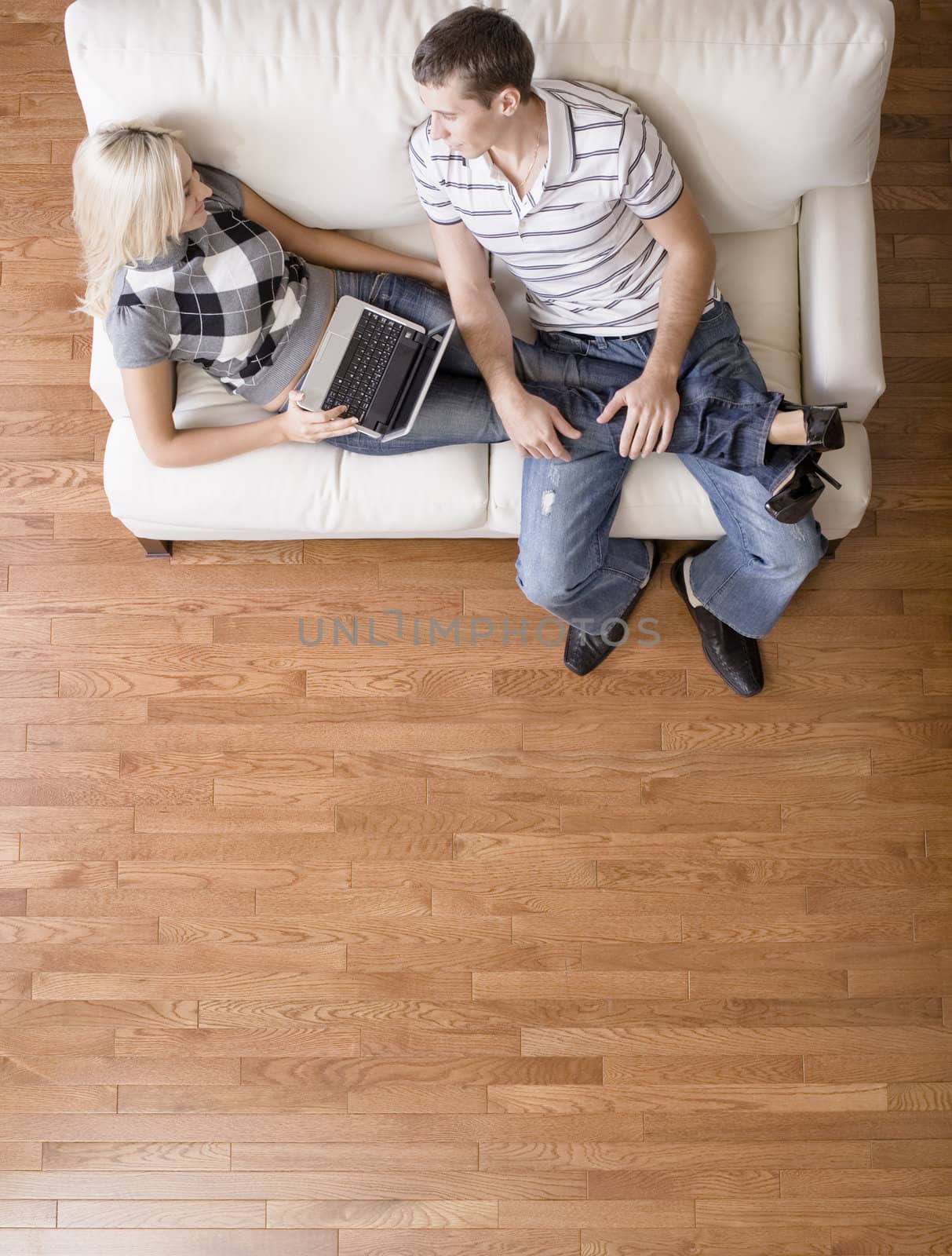 Overhead View of Couple Relaxing on Couch by cardmaverick