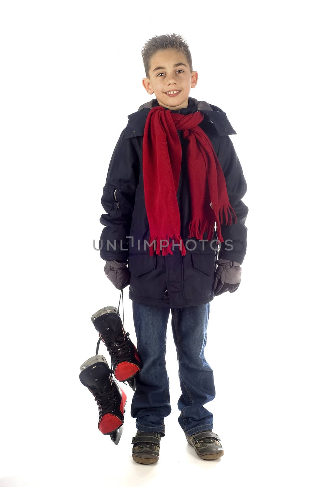 a young boy holding his skates
