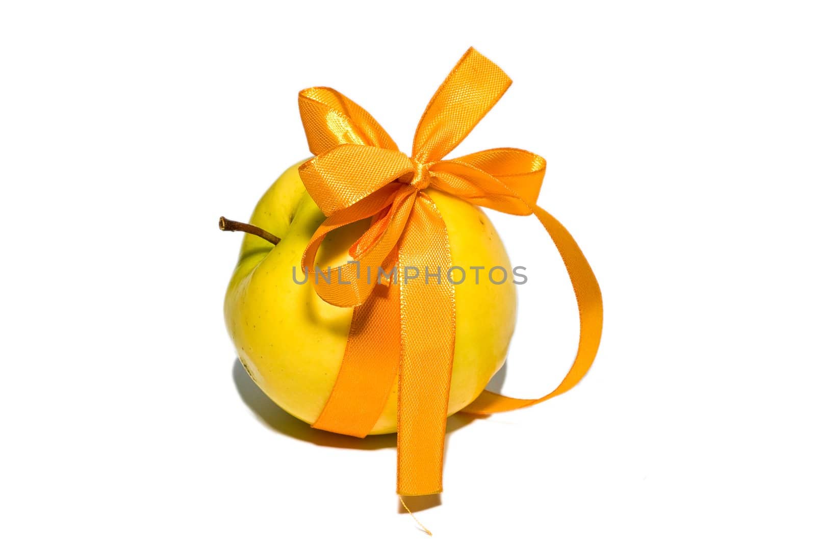 yellow apple with a gift bow on a white background