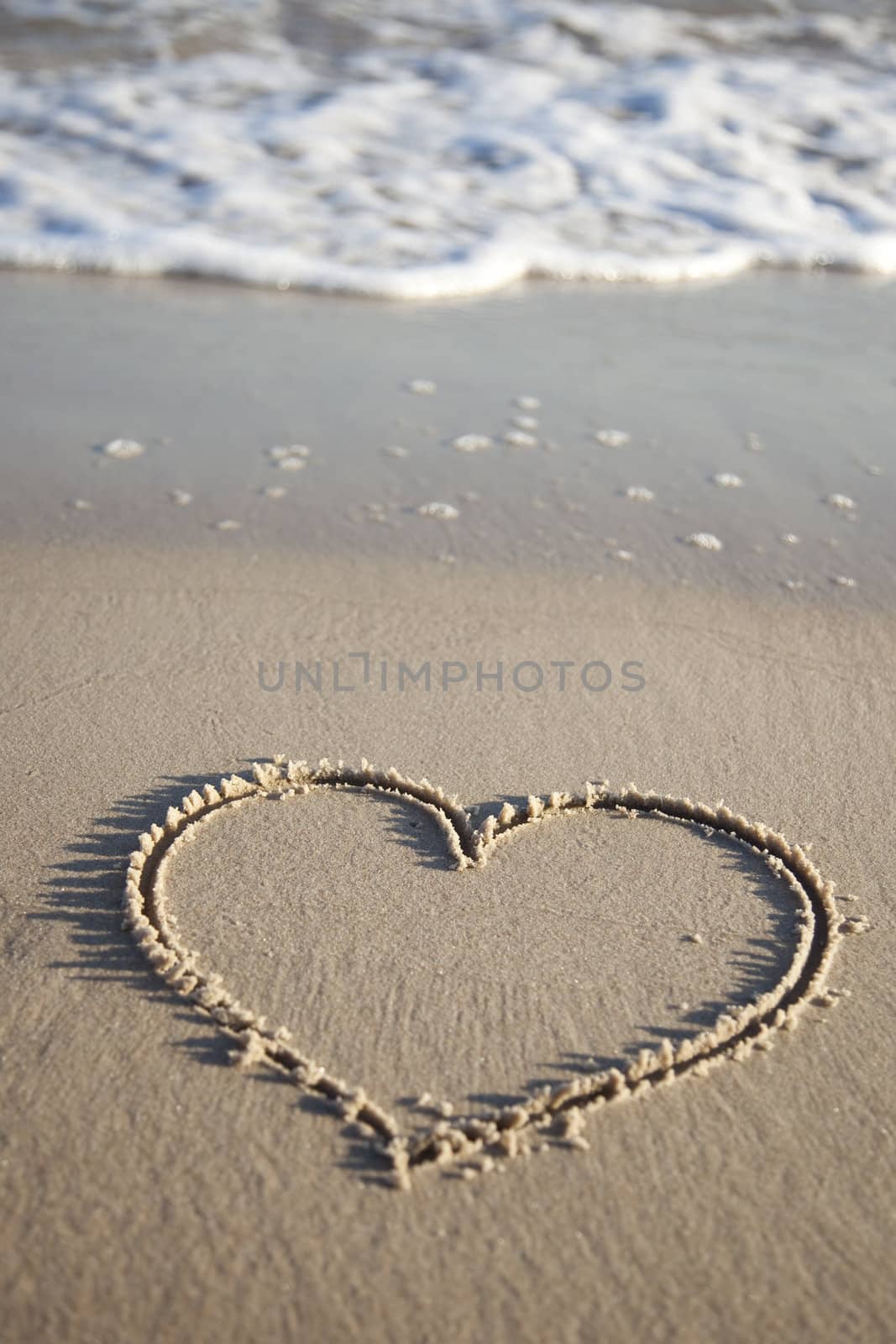 Heart painted on wet sand