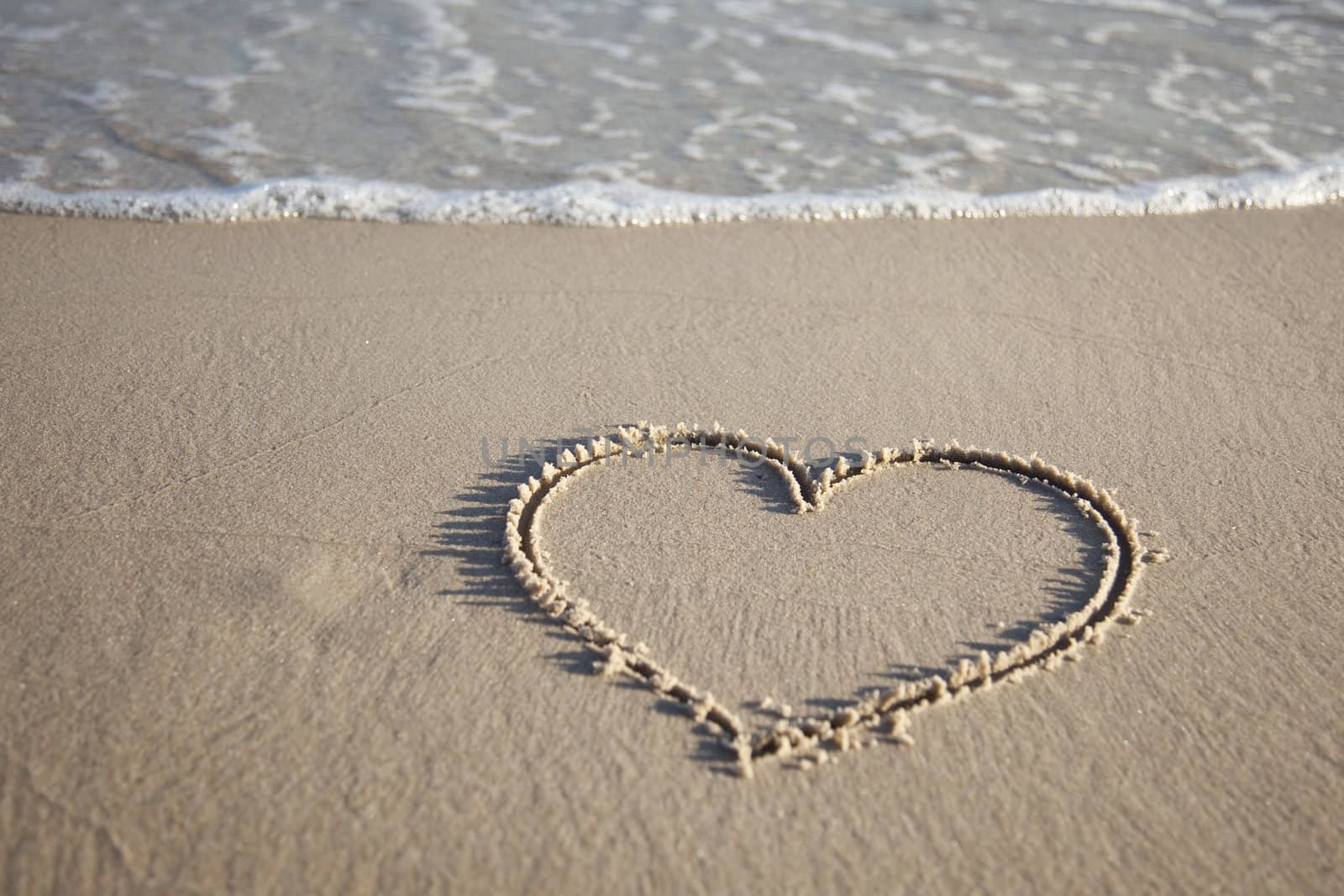 Heart painted on wet sand