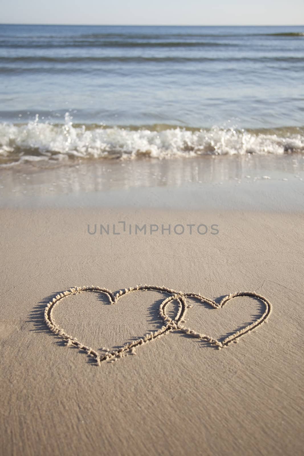 Hearts painted on wet sand by shiffti