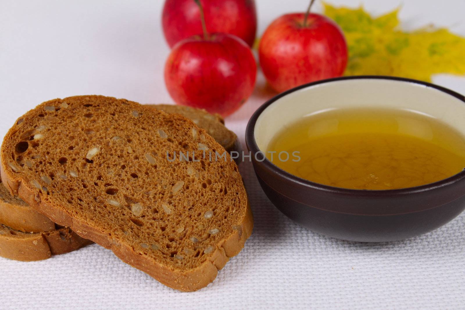 Black bread with honey and apples on a rough linen napkin