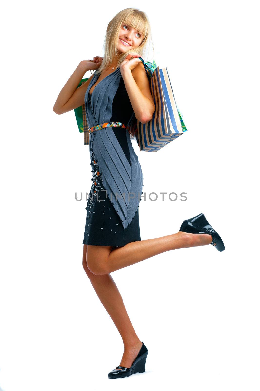 The fair-haired  curious smiling woman standing on white background whith parcels