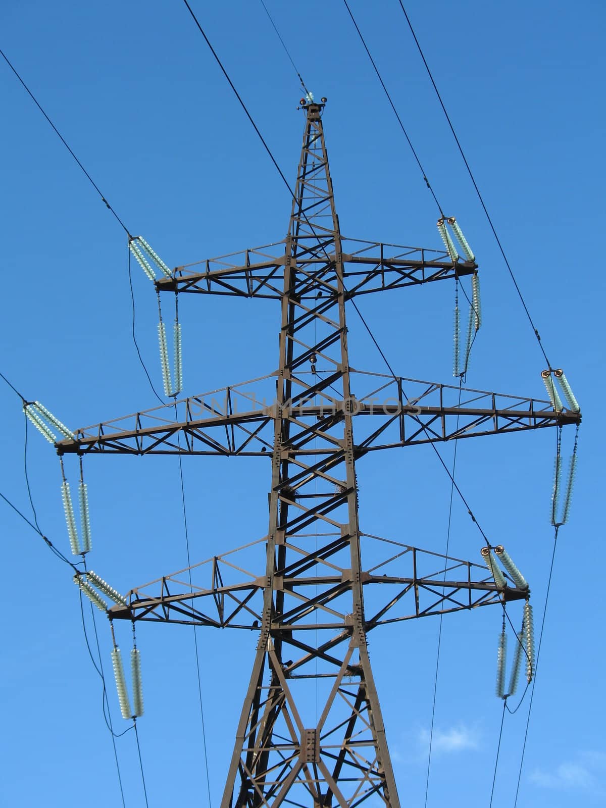 Support of a line of high-voltage electricity transmissions on a background of the blue sky, (look similar images in my portfolio)