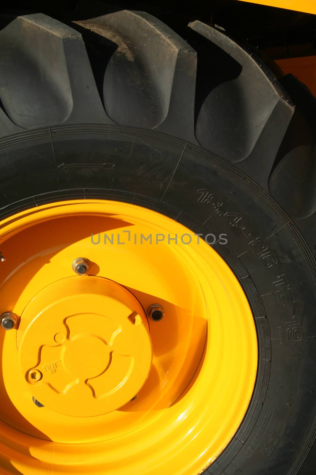 New wheel of a yellow building tractor with bracing, (look similar images in my portfolio)