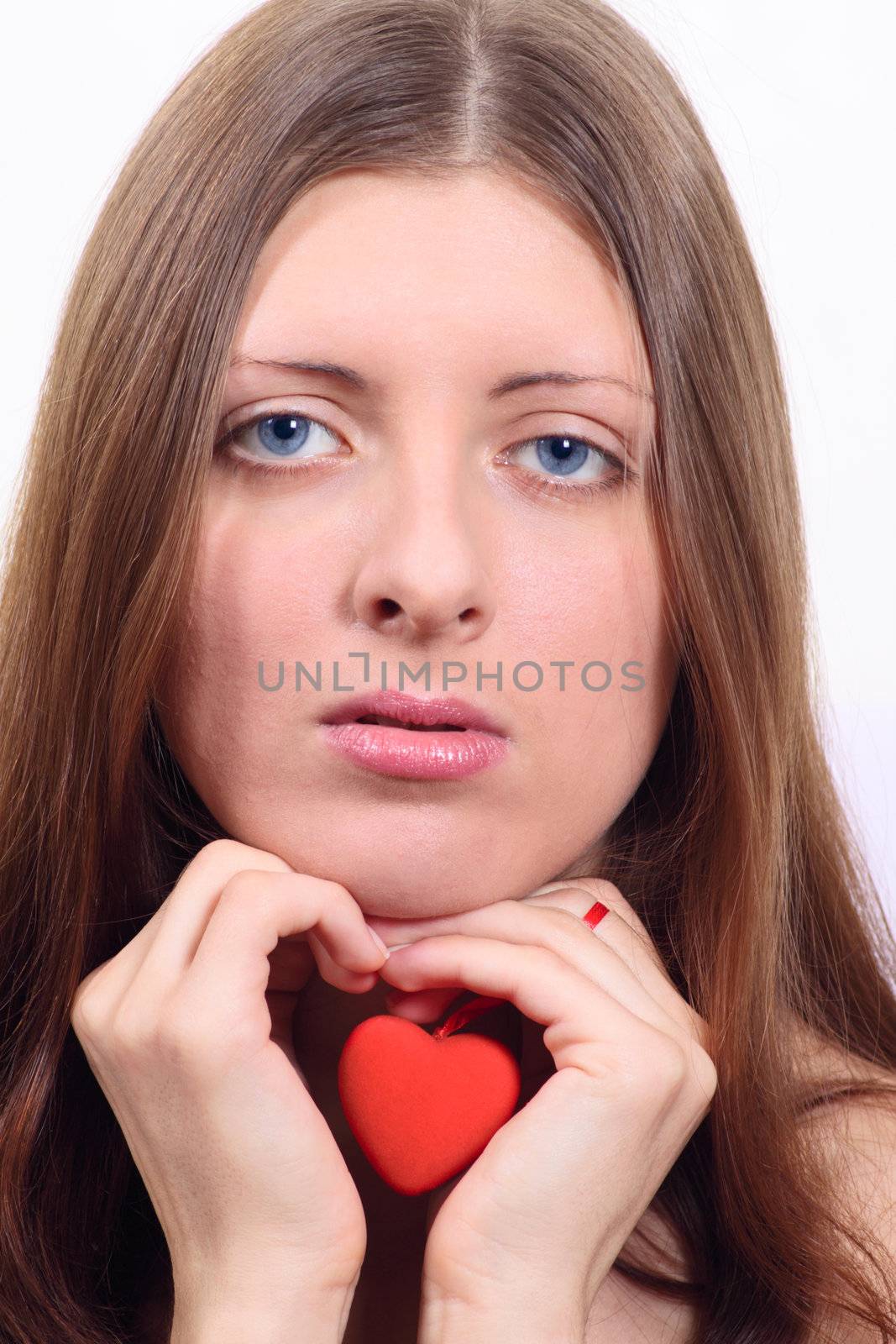 Portrait of the nice girl having control over toy heart removed close up