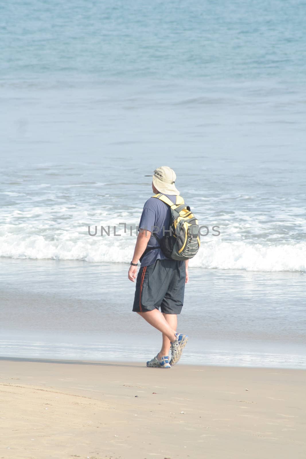 Tourist walking on beach