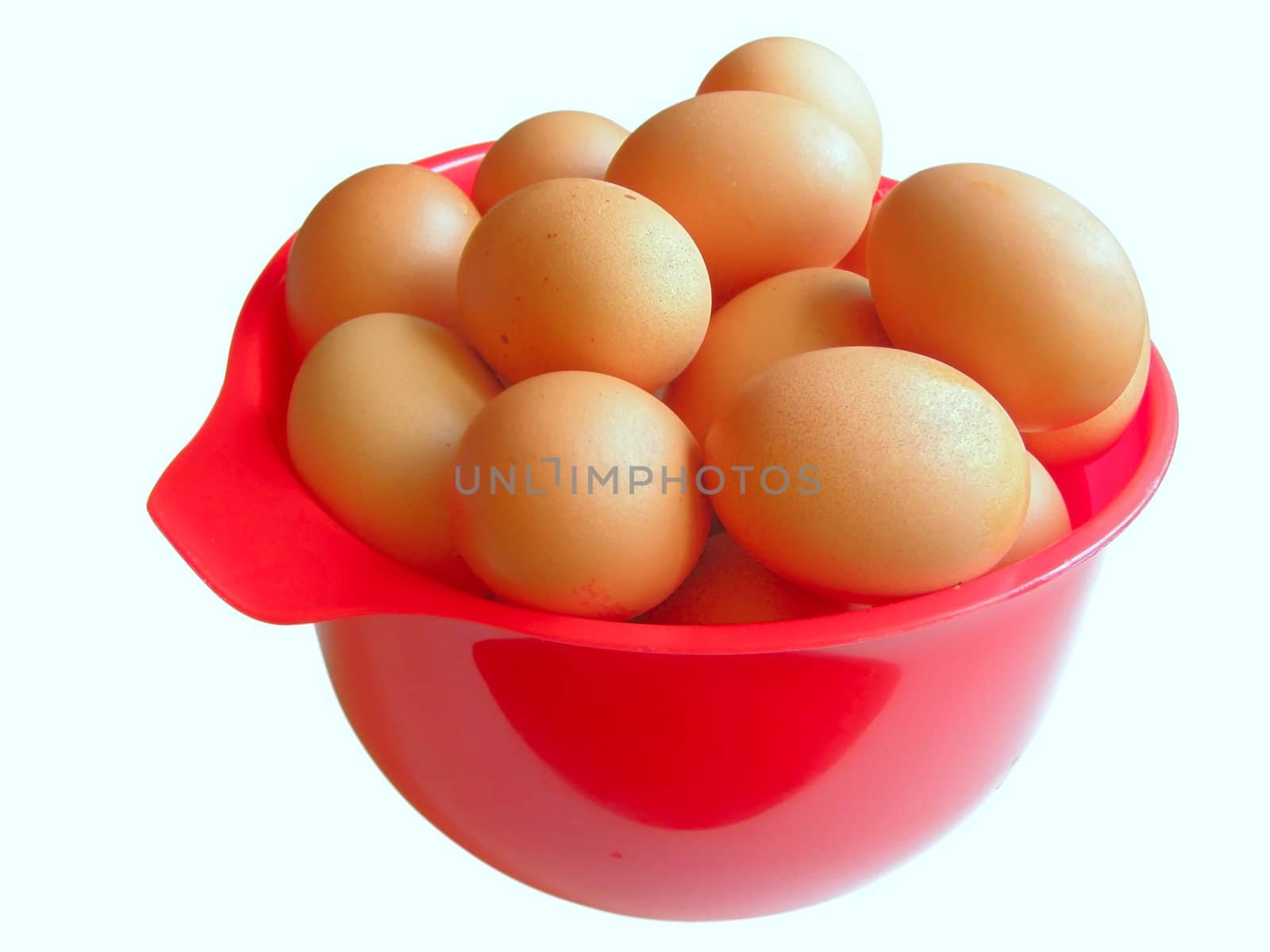 a lot of chicken eggs in the red bowl   