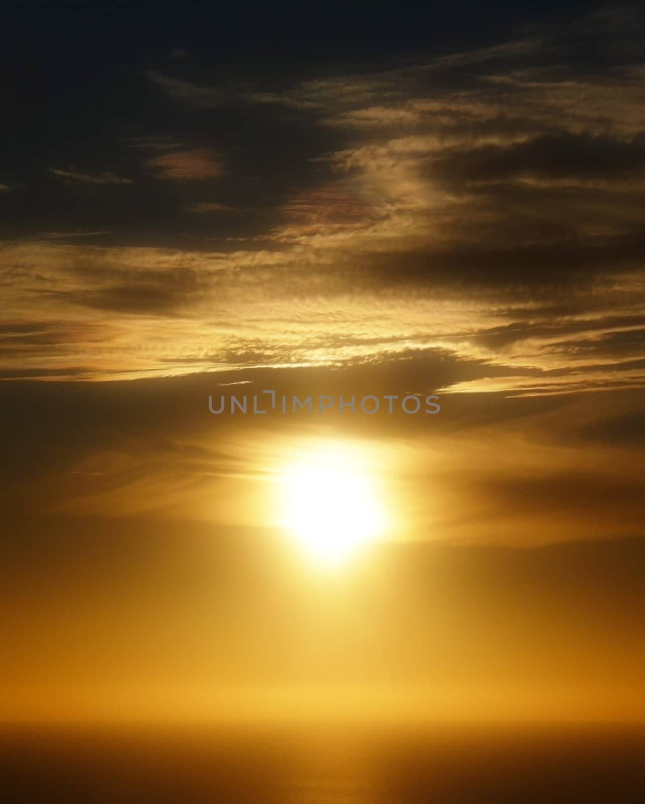 A cloudy tropical sunset view over the ocean.