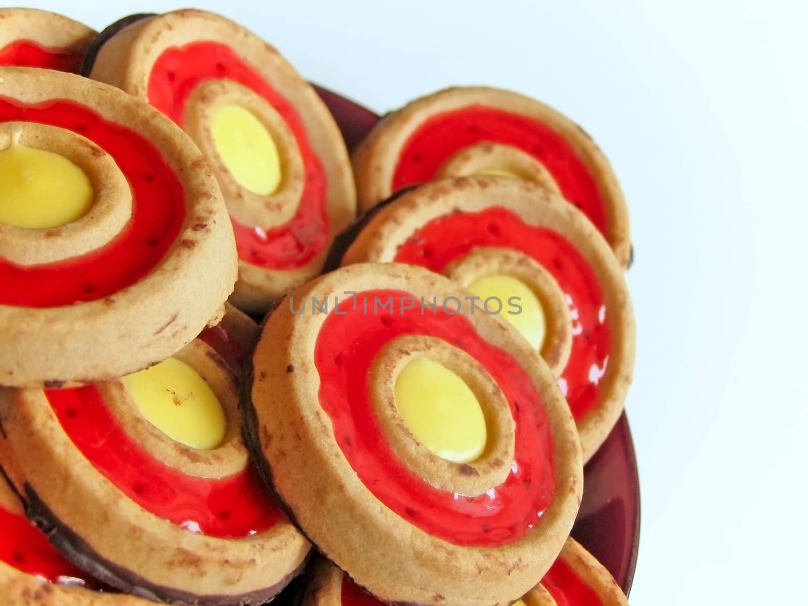 sweet cakes on the saucer over white background