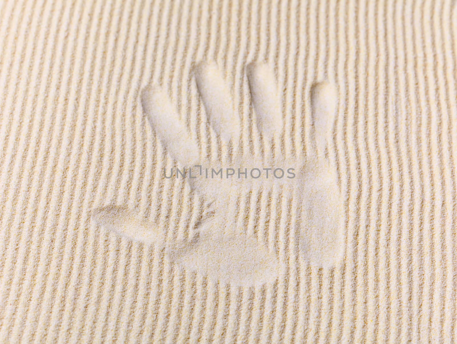 Trace from a palm on a sand surface