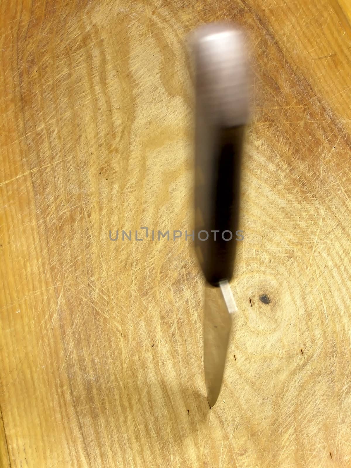 Swayed kitchen knife in the cutting board